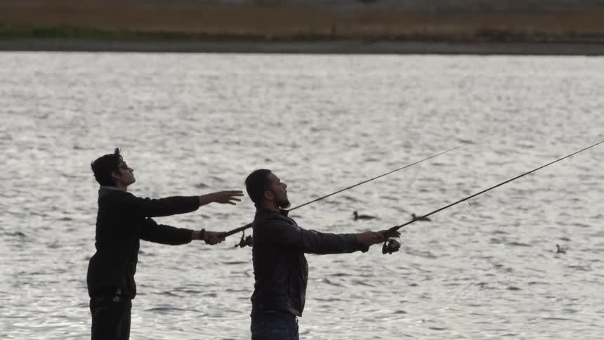 Two people fishing from the shore