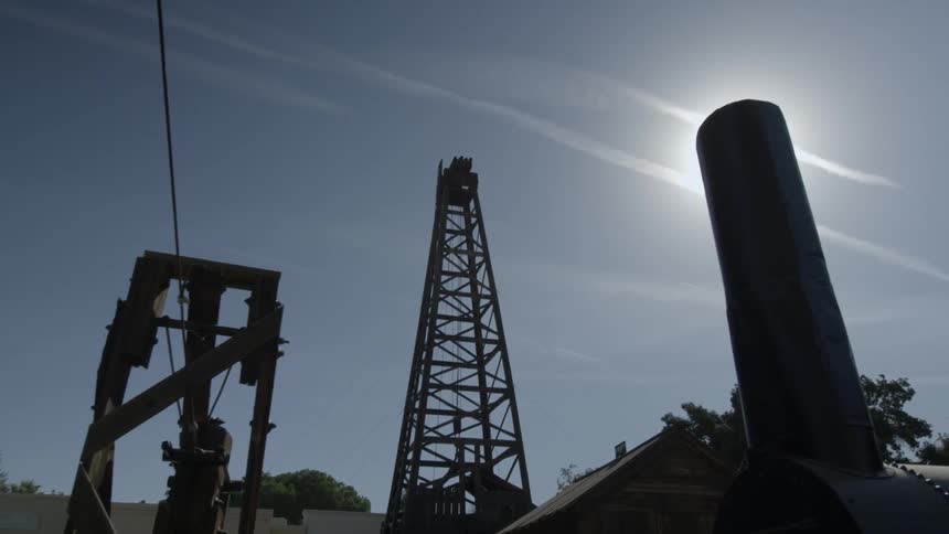 A metal tower rises into the clear sky above