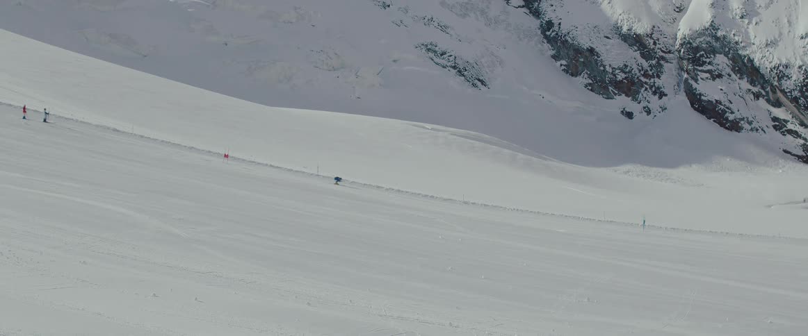 An olympic skier trains on a snowy mountain