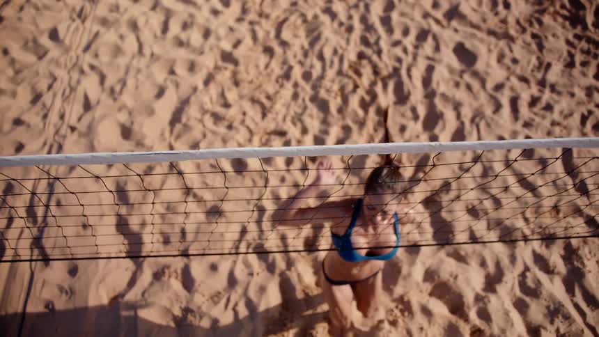 Woman on a sand court playing volleyball