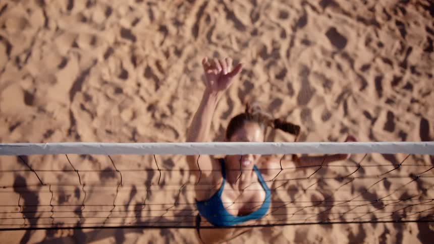 A woman strikes the ball during a volleyball game