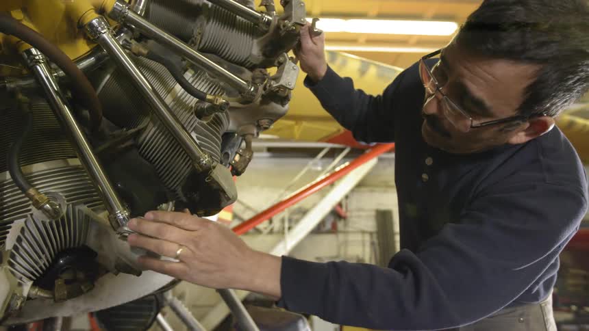 A man is working on an engine