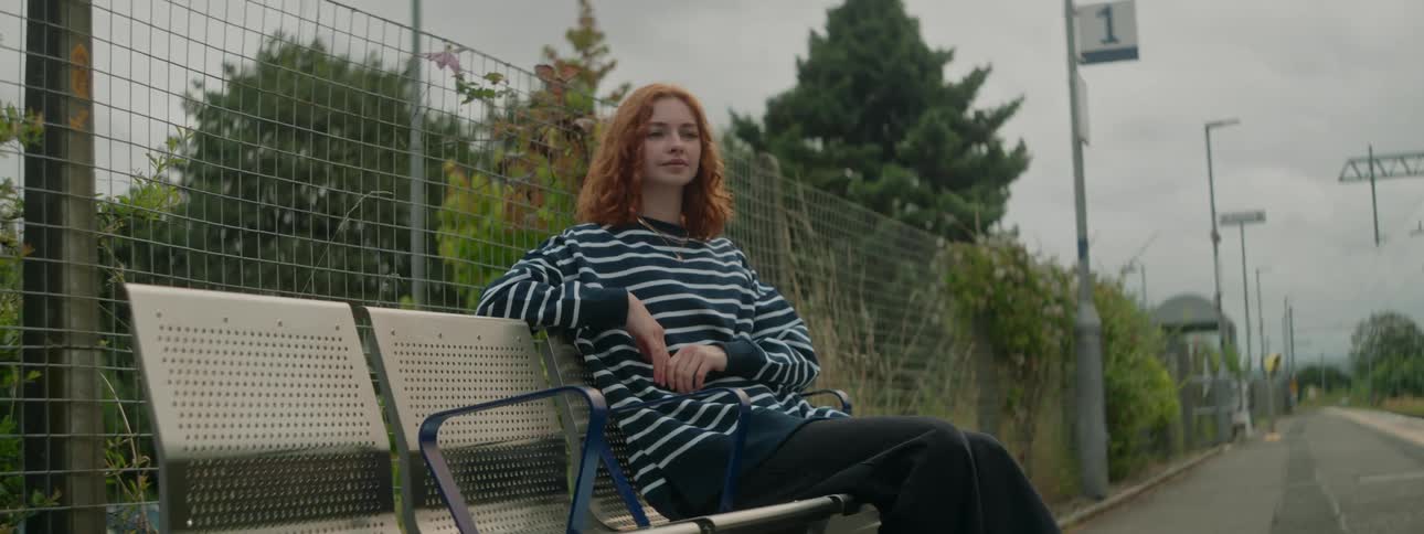 A clip of a lady sitting on a chair outdoor
