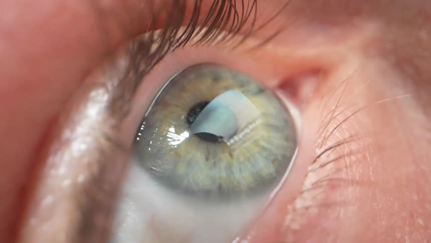 Cell phone screen reflecting in a persons eye