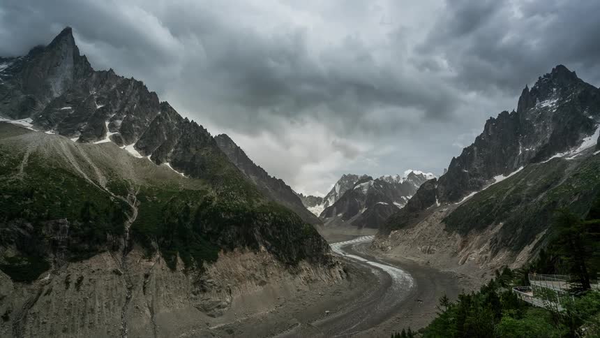 A panoramic view of a majestic mountain range with snowcapped peaks