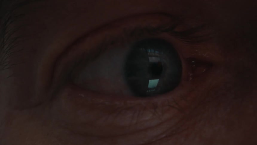Closeup of a persons blue eye looking at a smartphone screen