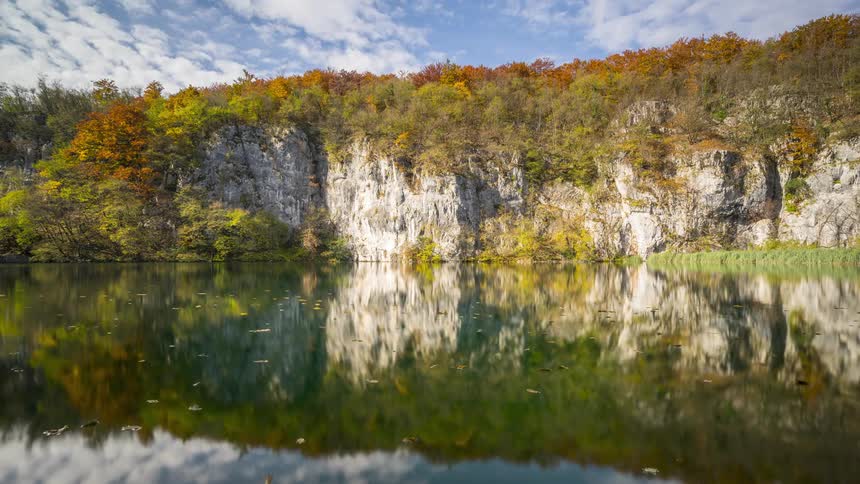 Landscape of a calm lake reflecting mountains in the background