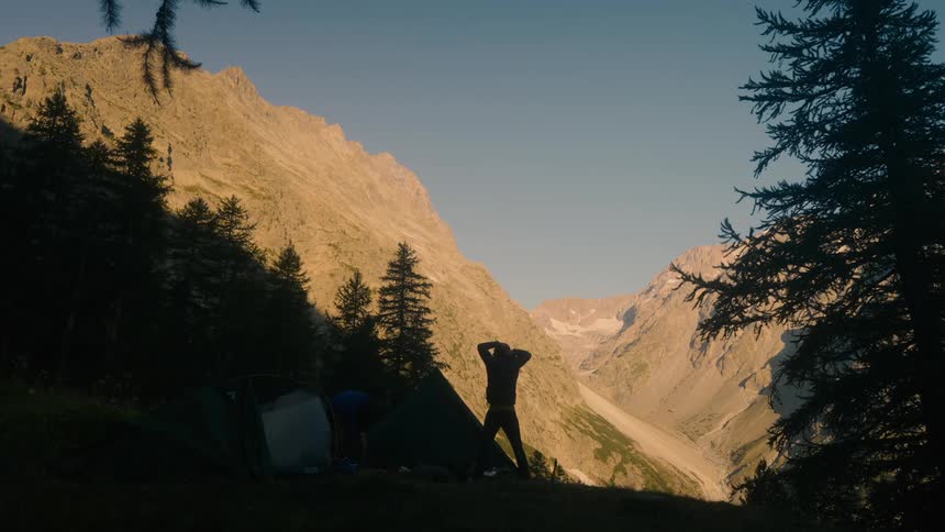 A clip of a person in front of a mountainous area
