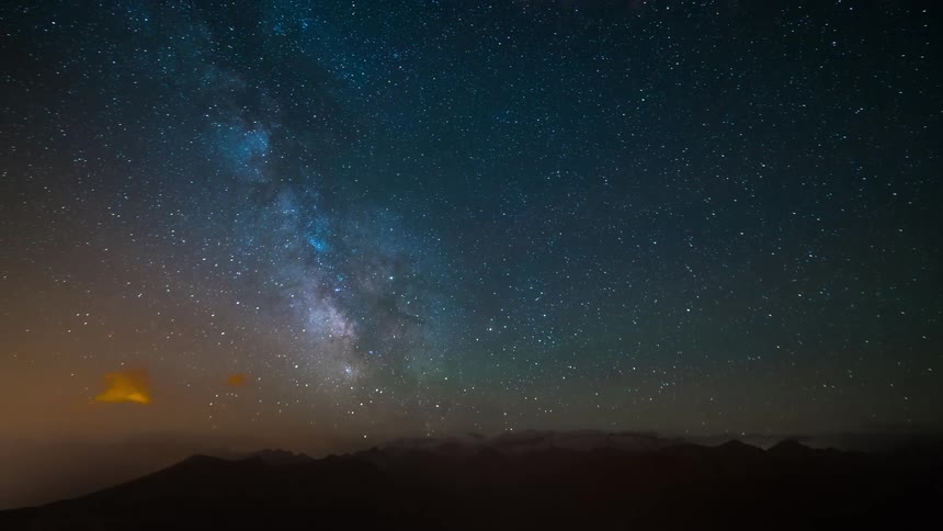 Landscape of starry sky and silhouette of mountains in the background