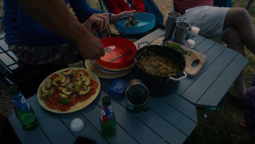 Person serving food on a blue plate