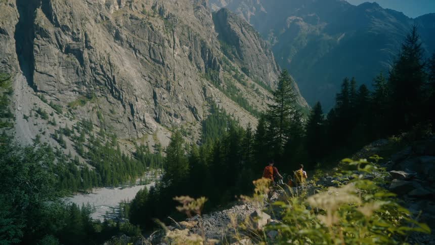 Group of people walking along a trail in a mountainous environment