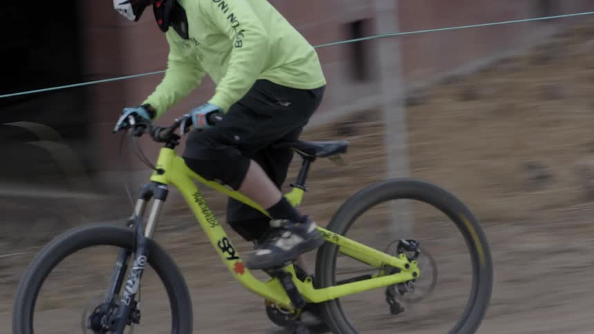 A man rides a bmx bike downhill jumping in the dirt