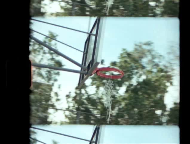 A basketball hoop with an orange rim and white strings