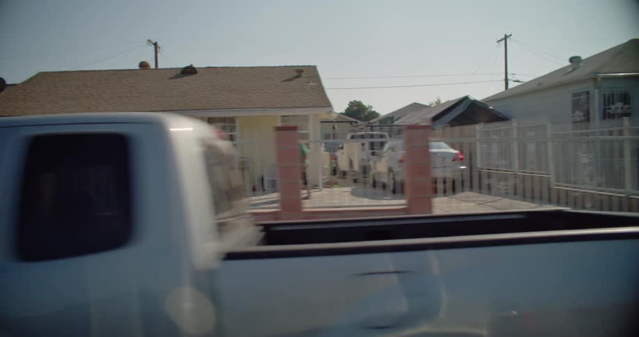 A colorful row of houses with cars parked nearby in the suburban area