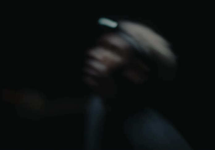A man is moving around in the dark