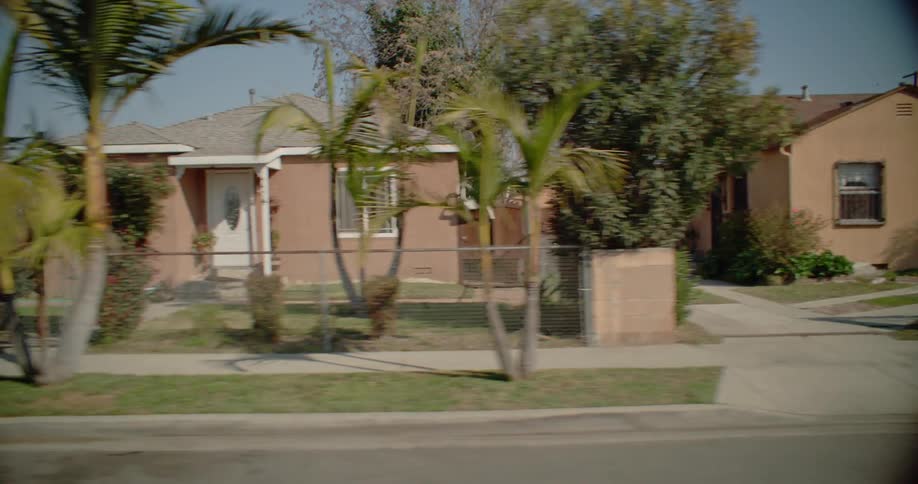 A row of classic california bungalows with neat lawns and tidy driveways paints a picture of suburban tranquility