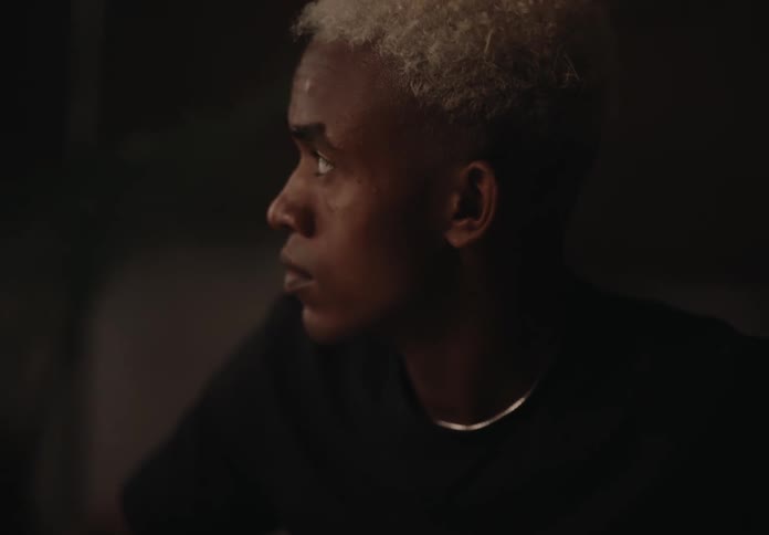 Close up of the face of a young man with yellow hair