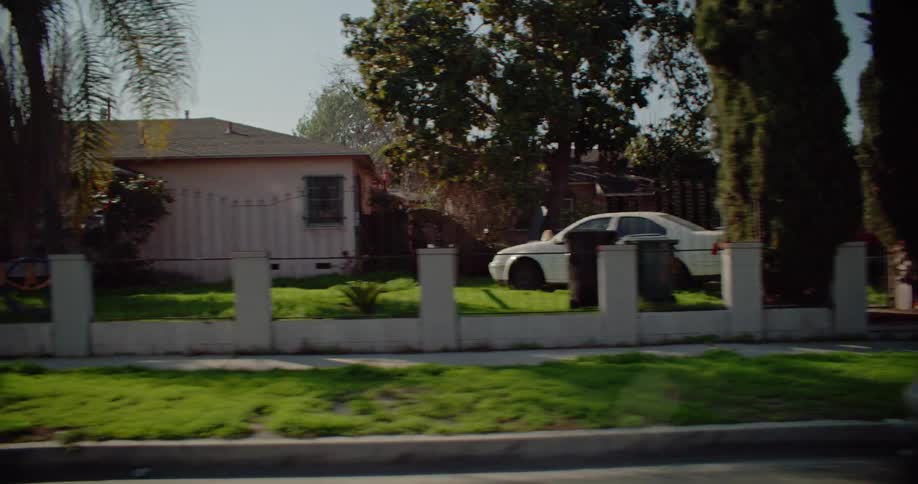 A row of classic california bungalows with neat lawns and tidy driveways