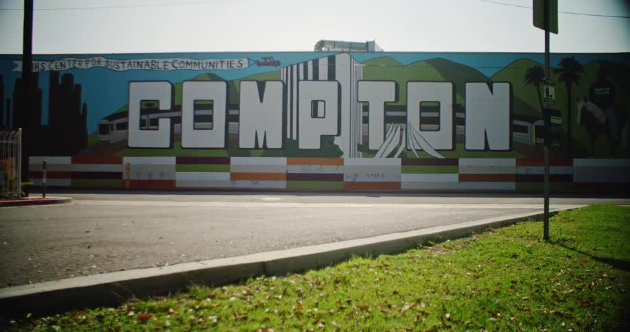 Street leads to the colorful compton mural on a sunny day