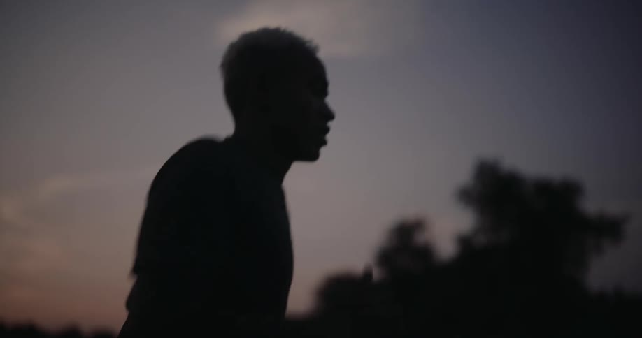 A man is running on a dark morning as he looks down