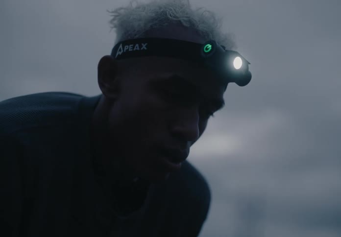 A person wearing a headlamp at twilight or dawn