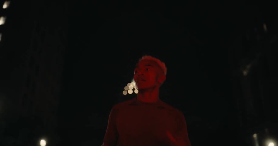 A man is running on the street at night