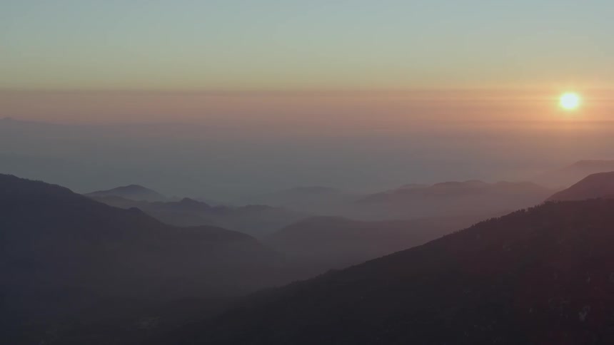 Hazy sunset beyond the mountains