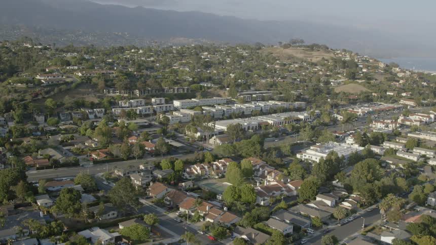 Aerial view of a city spread out with hills in the background