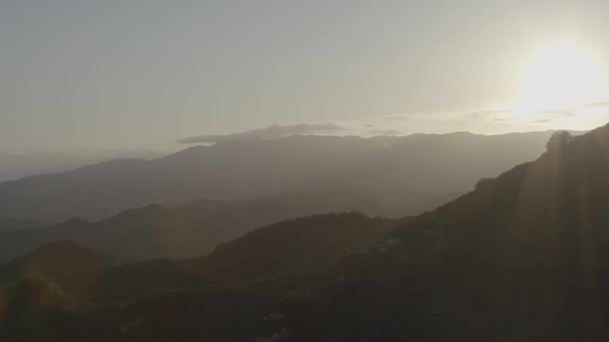 Aerial view of a sunset over clouds and mountains