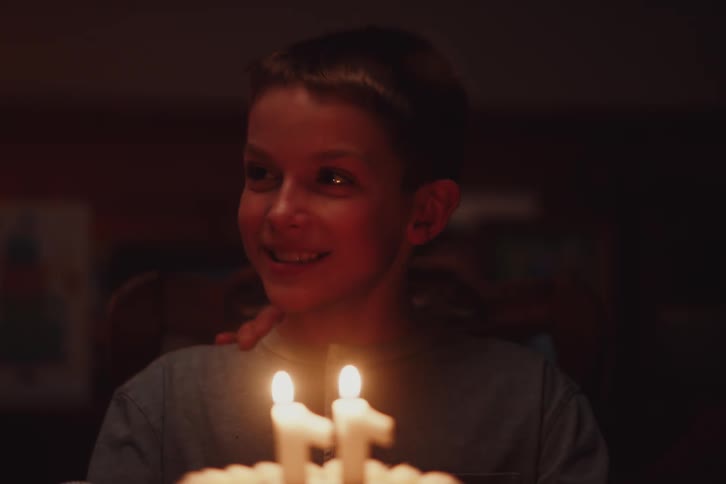 A clip of a boy celebrating a birthday with a cake