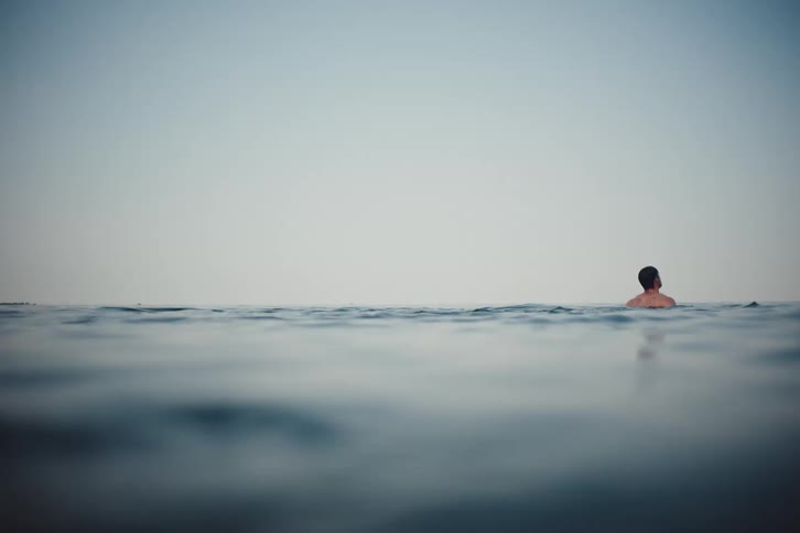 A man is swimming in the water