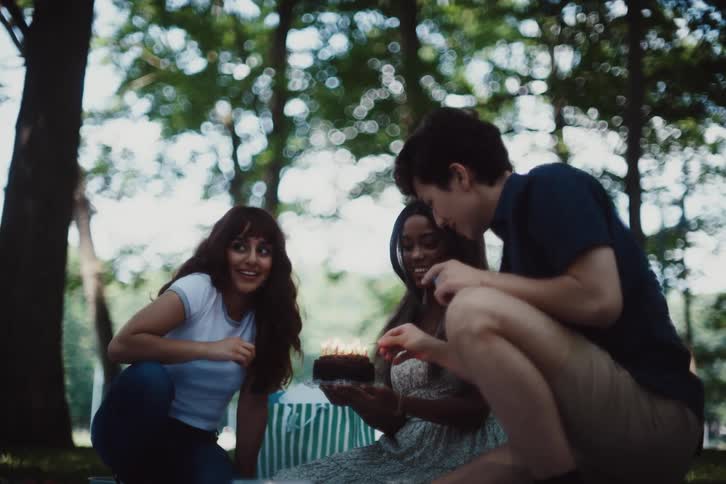 Friends celebrate a birthday with a cake