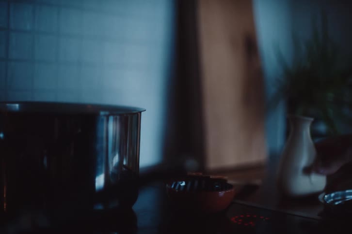 A person is pouring ingredients in the pot