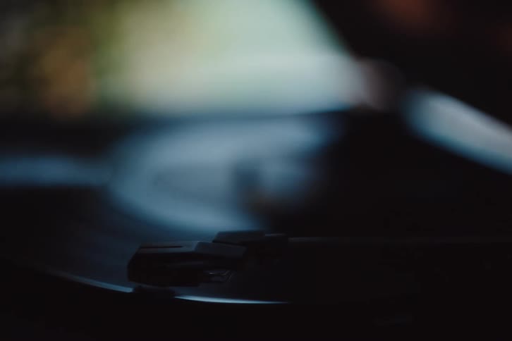 Hand putting a vinyl record to play