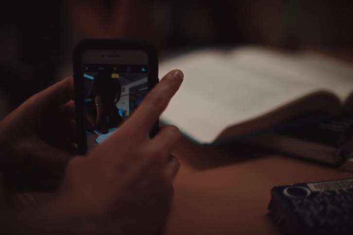 Hands interacting with a smartphone and taking a picture of another person