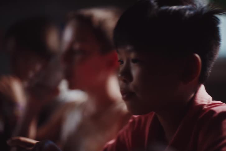 Children sitting at a table drinking and eating