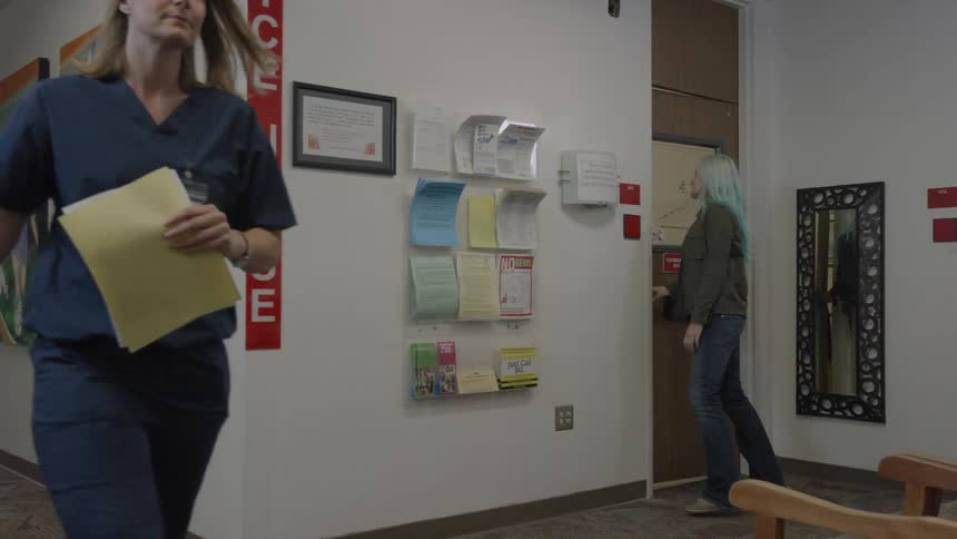Women walk in the hallway of a health clinic