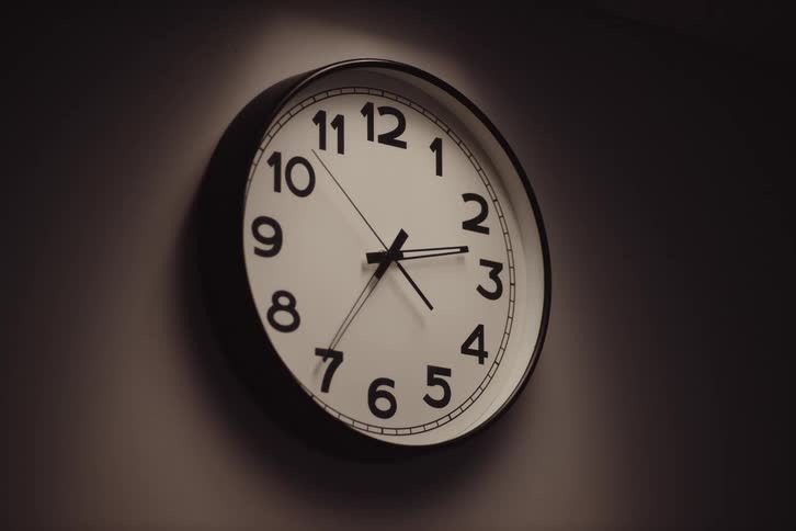 Analog clock on the wall with moving second hand