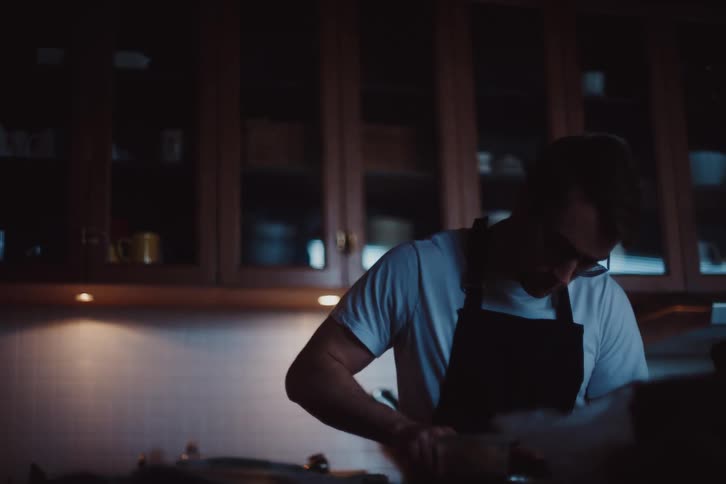 A clip of a male cooking in the kitchen