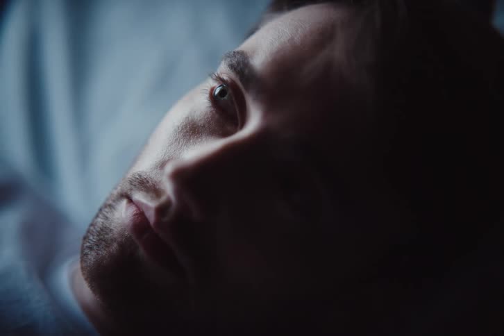 A clip of a man waking up from sleep