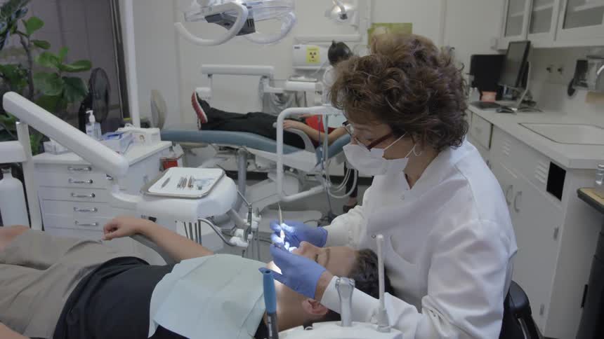 Dentists are working on patients in a dental office