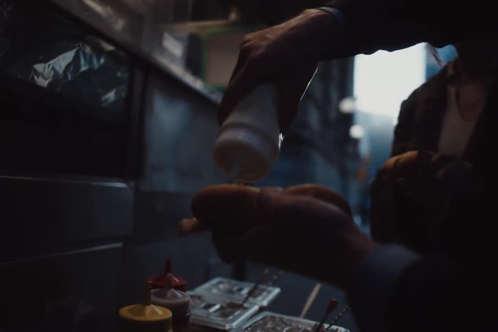 Man and woman preparing their own hot dogs in a food truck