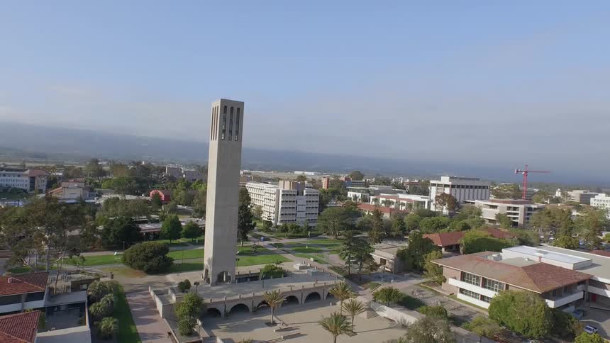 A tall tower sits in this town on a clear day