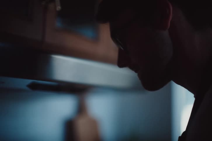 A man is mixing food in the pan
