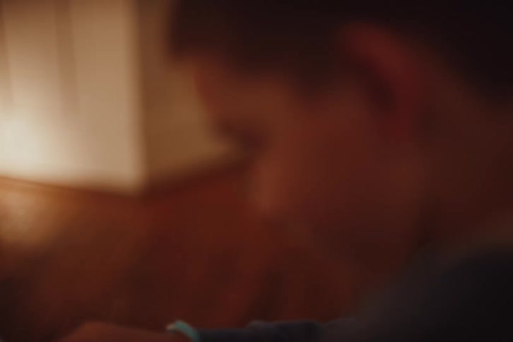 A child carefully examines a handwritten letter and opens it