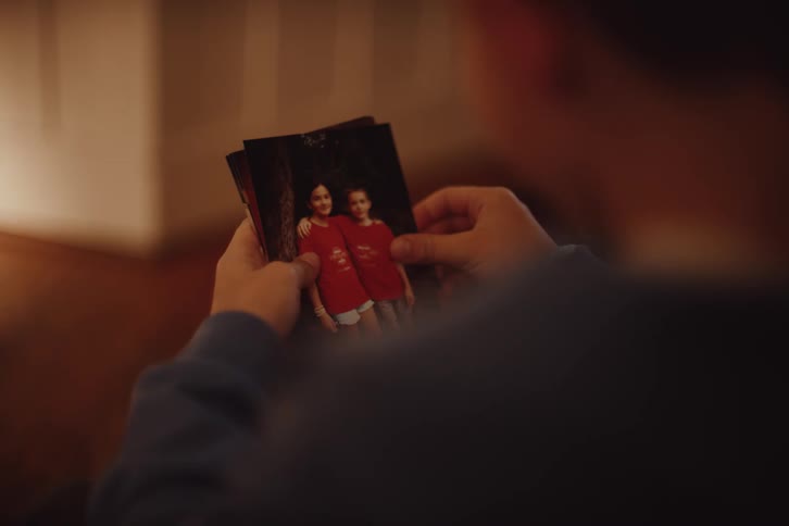 Boy reading a letter and looking at photos of friends
