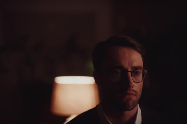 Portrait of a man in a lowlight environment looking thoughtful