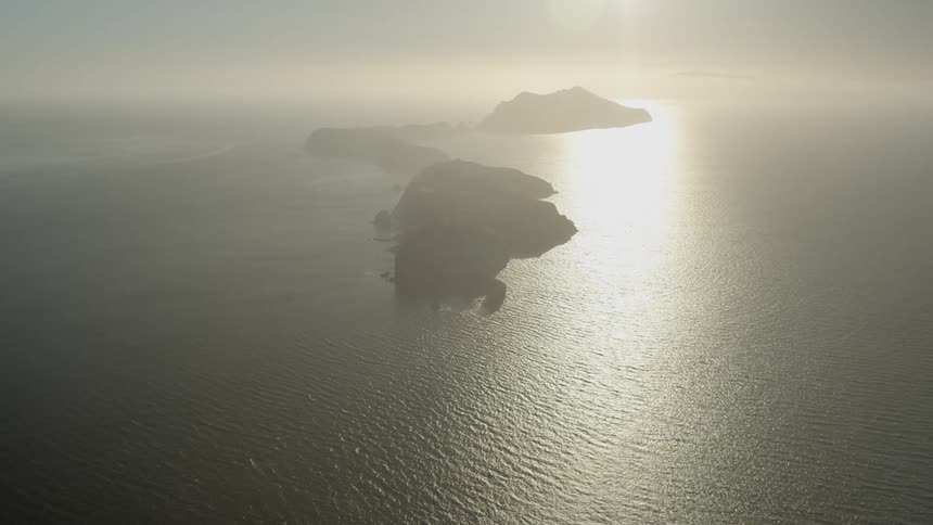The sun shines down on islands in the ocean