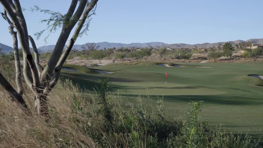 A view of a green golf course on a sunny day