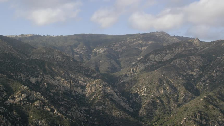 Mountains lay still beneath the clouds